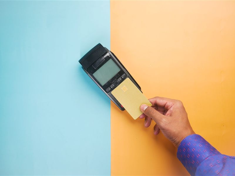 A customer tapping a card on a payment terminal